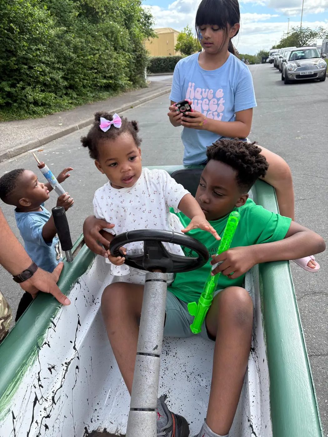 Children steering a soapbox cart