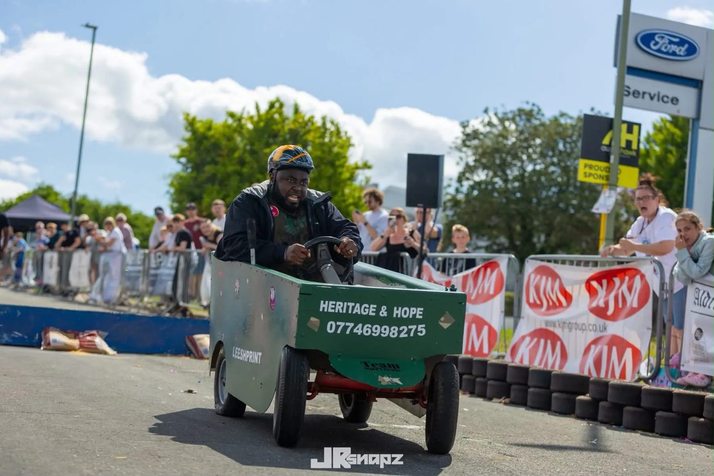 Team running with their soapbox cart during the race
