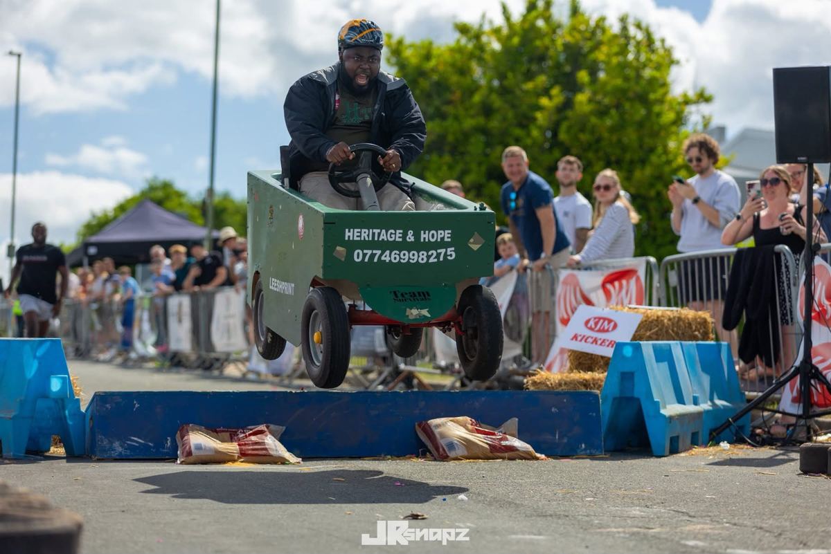 Team member jumping in celebration at the soapbox derby