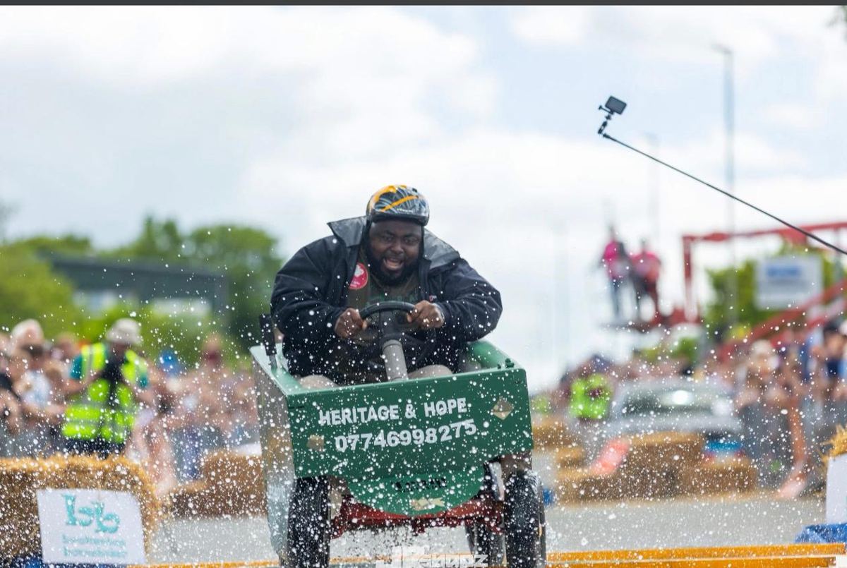 Soapbox cart splashing through water on the course