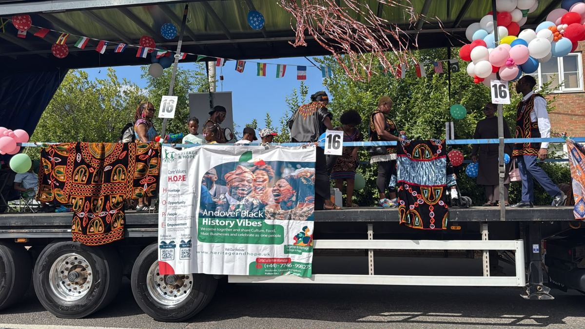 Carnival float carrying the Heritage & Hope banner